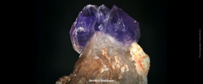 A transparent light purple raw gemstone: amethyst