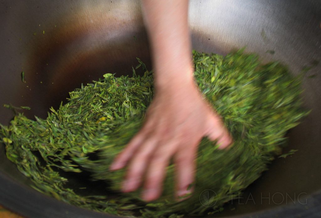 Wok roasting in Longjing green tea production