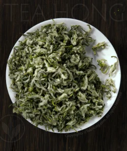 Fine silvery hairs cover he beautifully rolled tiny leaves of the green tea Biluochun.