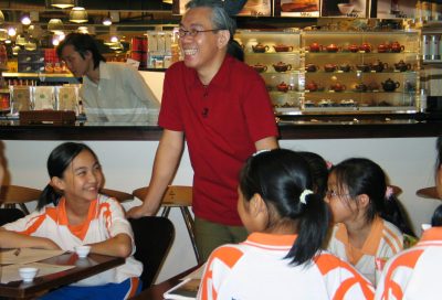 Leo sharing a joke with school kids at tea bar