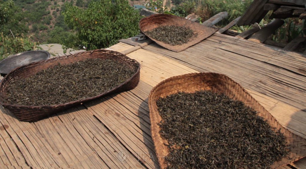 Shallow bamboo baskets with maocha on the roof of a tea picker's home.