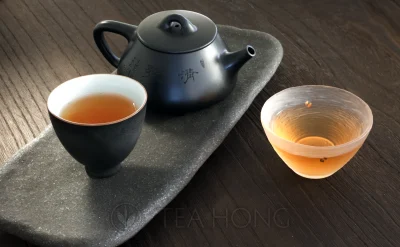 Two strongly brewed cups of Fengxi Old Ginger Phoenix oolong from a small Yixing teapot