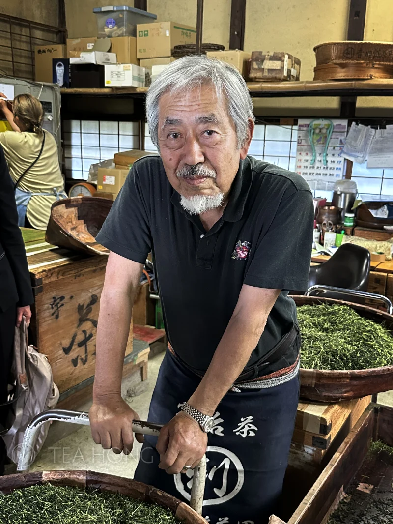 Portrait of an old man in a traditional Japanese tea production workshop