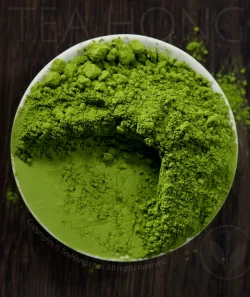 The intense green colour of Tea Hong's Ise Matcha Mugetsu of a tea dish fully heaped with the powdered tea