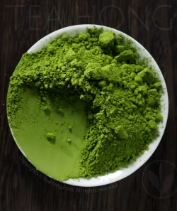 A dishful of Tea Hong's Uji Matcha Tokumukashi with a corner scrapped, turning the tae powder into a flat smooth surface, showing the fineness of the grinding.