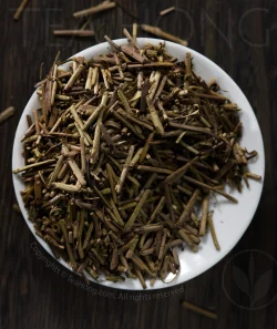 A tea dish filled with the evenly deep roasted tea petioles that are Tea Hong's specially selected FIR Boucha