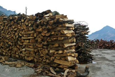 Two huge walls of firewood piled up neatly in a front yard overlooking the Fengxi valley