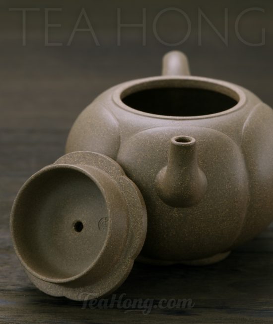 Qin Mu Yun: Plum Blossom, a Yixing green ash duan-ni teapot A Yixing teapot handcrafted by Qin Mu Yun: front view with the lid rested on side of the teapot