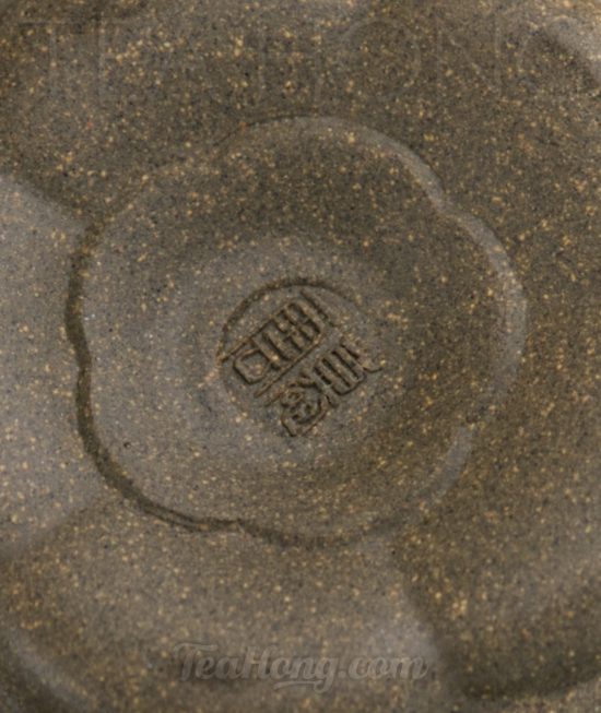 Qin Mu Yun: Plum Blossom, a Yixing green ash duan-ni teapot A Yixing teapot handcrafted by Qin Mu Yun: closeup showing the artist seal on the teapot bottom