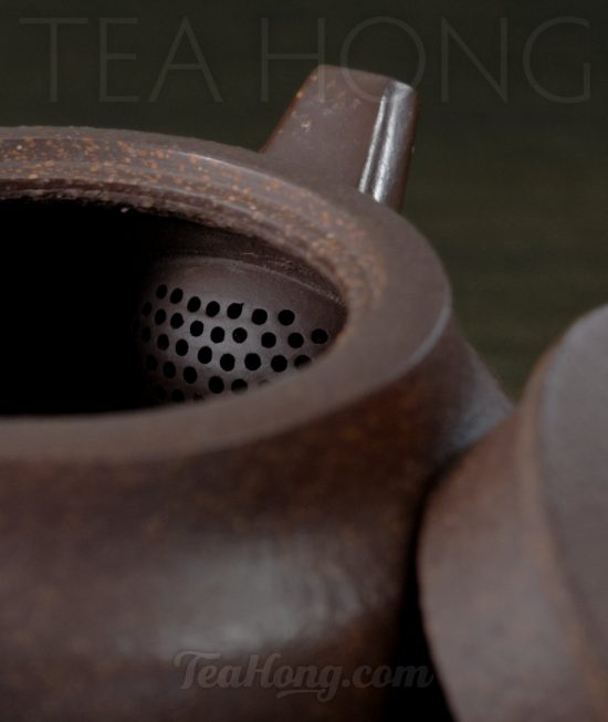 Zhang Jing Ming: Compass A Yixing teapot handcrafted by Zhang Jing Ming: with the lid open showing the opening and the strainer of the teapot