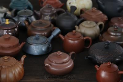 An array of numerous teapots in different colours, shapes and designs, but all made with different clays, many are Yixing clays