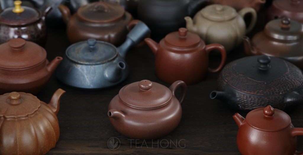 An array of numerous teapots in different colours, shapes and designs, but all made with different clays, many are Yixing clays