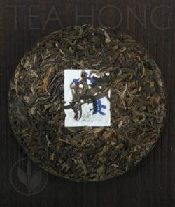 The front side of the Inner Primeval Earth cha bing unwrapped, showing the beautifully compressed tealeaves