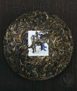 The front side of the Inner Primeval Earth cha bing unwrapped, showing the beautifully compressed tealeaves