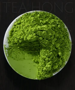 A round white dish filled with a pile of intensely green matcha