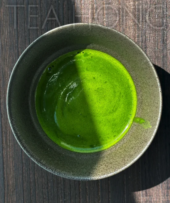 Nishio Matcha semi- Koicha top view of a bowl of matcha in an intense green colour, with a swirl of thin foam on the surface.