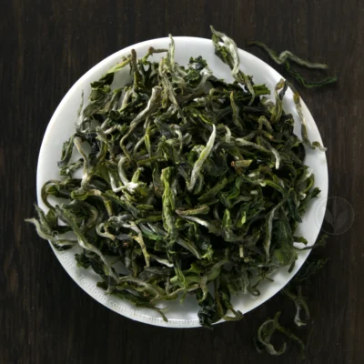 The beautiful tealeaves of Sanxia Biluochun piled up in a small round white dish
