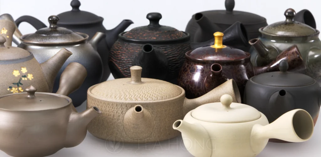 a large group of Japanese teapots