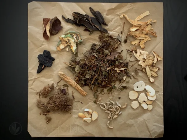 a large variety of dried herbs spread on a piece of paper, typically used to wrap the content as a package.