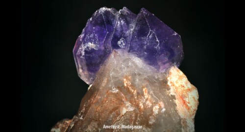A transparent light purple raw gemstone: amethyst