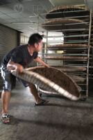 Laying rolled tealeaves in layers of bamboo basket for further oxidation