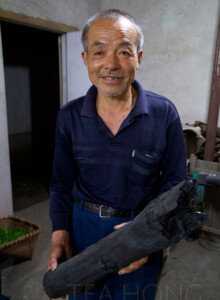 "This charcoal is very different from what you can buy from the shop," said Master Wang. "I made all the charcoal myself from trees around here that I know can yield a good smell when burning." He posted for me after walking me to the charcoal making hut and his showing off his charcoal pile. It was too dark outside already, so we went back to his workshop to picture this. An old man holding a perfect looking log of wood charcoal